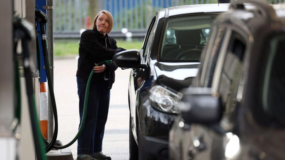 A woman fills her car up with diesel