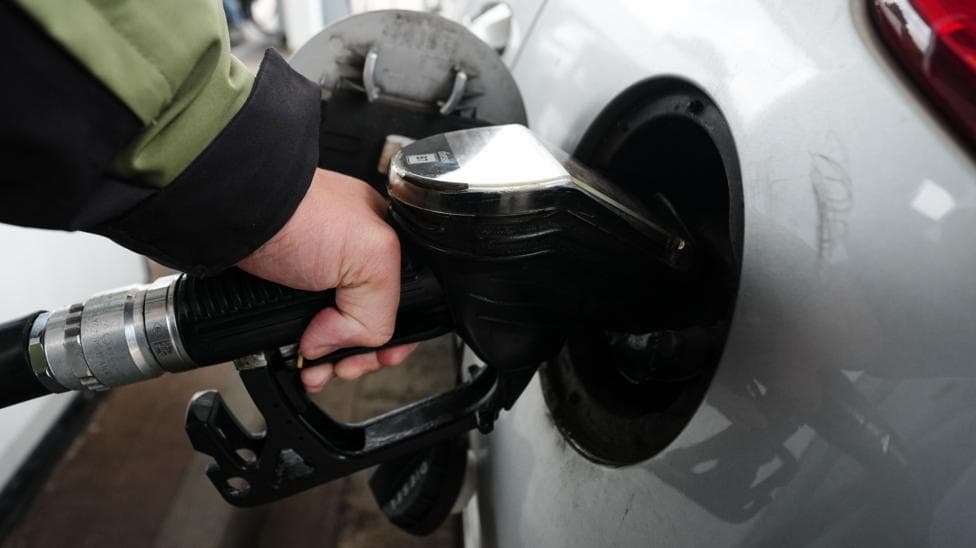 Person holding a diesel pump and filling up their car