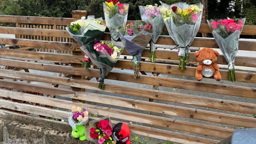 Floral tributes and teddy bears left at the scene where six year old boy died