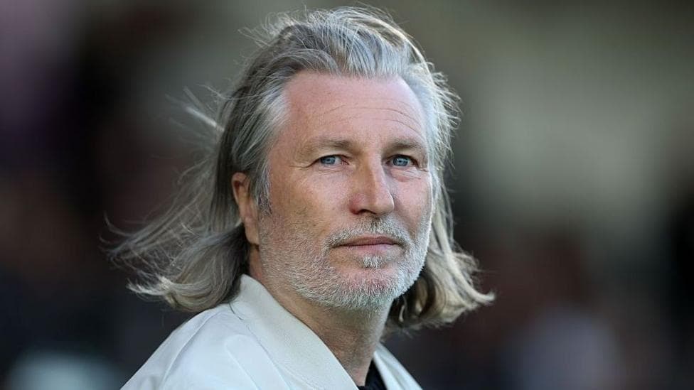 Robbie Savage looks on during a Forest Green Rovers match