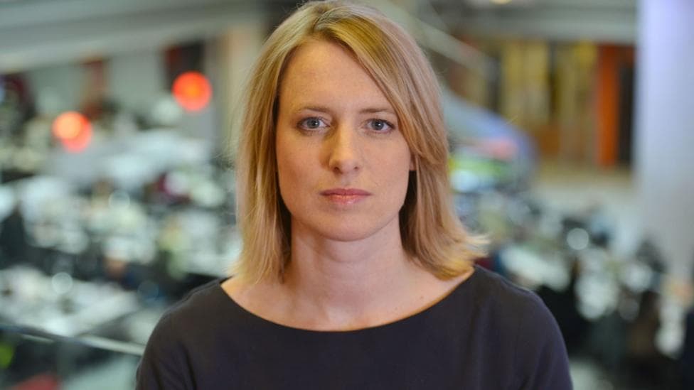 Rachel Jupp pictured against the backdrop of the news room in New Broadcasting House