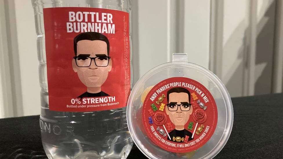 A bottle with Bottler Burnham written on it under a cartoon image of the PM wearing glasses and Andy Panders' People Pleaser Pick N Mix