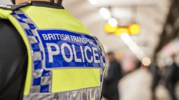 The back of a British Transport Police vest. It is yellow with blue and silver markings.