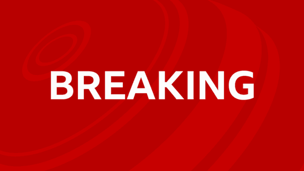 The word 'breaking' is written in white on a red background with lighter concentric red circles looping round.