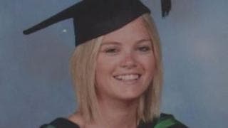 Louise Corbett Gibbons. She has shoulder-length blonde hair, wearing a black graduation cap and green and black robes.
