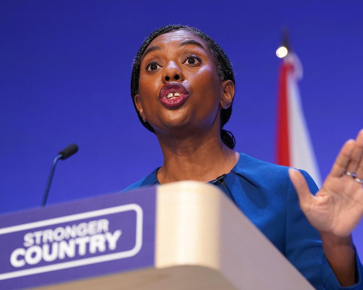 Kemi Badenoch speaks animatedly at a podium that says 'stronger country' during her speech at Conservative party conference