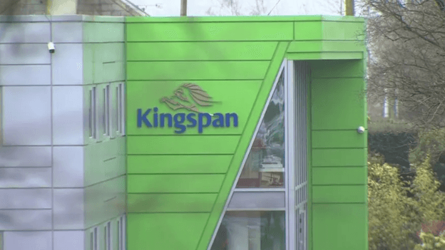 A green and grey building with the Kingspan logo on it.
