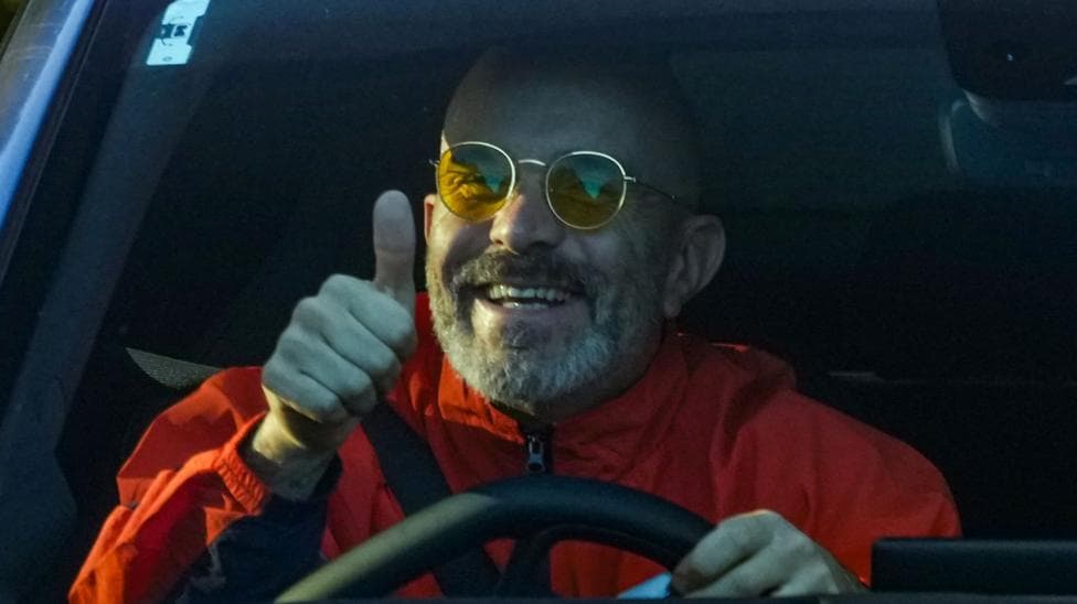 Manchester City manager Enzo Maresca gives a thumbs-up as he arrives at the City Football Academy in his car