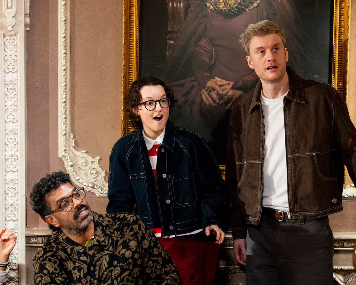 Romesh Ranganathan, Bella Ramsay and James Acaster react with surprised expressions in The Celebrity Traitors