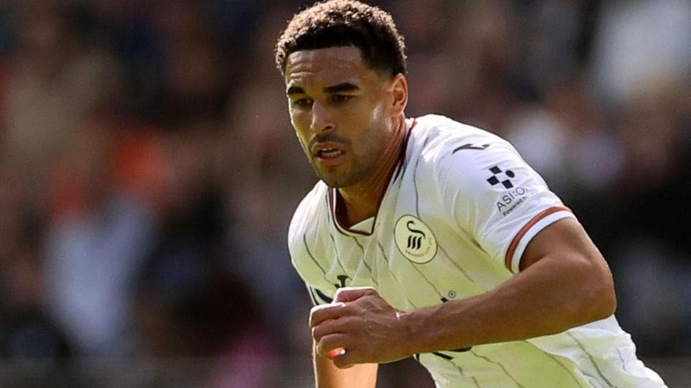 Ben Cabango competes for the ball with Swansea
