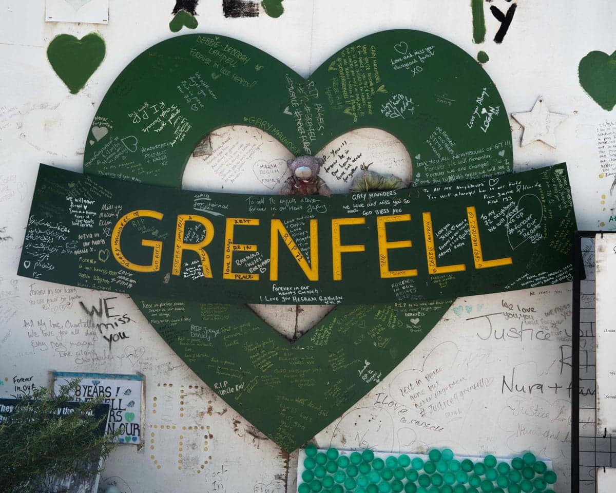 The Grenfell Tower memorial wall, a green heart covered in handwritten tributes