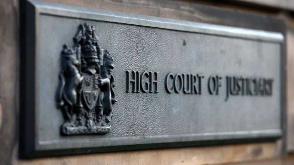 Sign outside Edinburgh High Court which says High Court of Justiciary.
