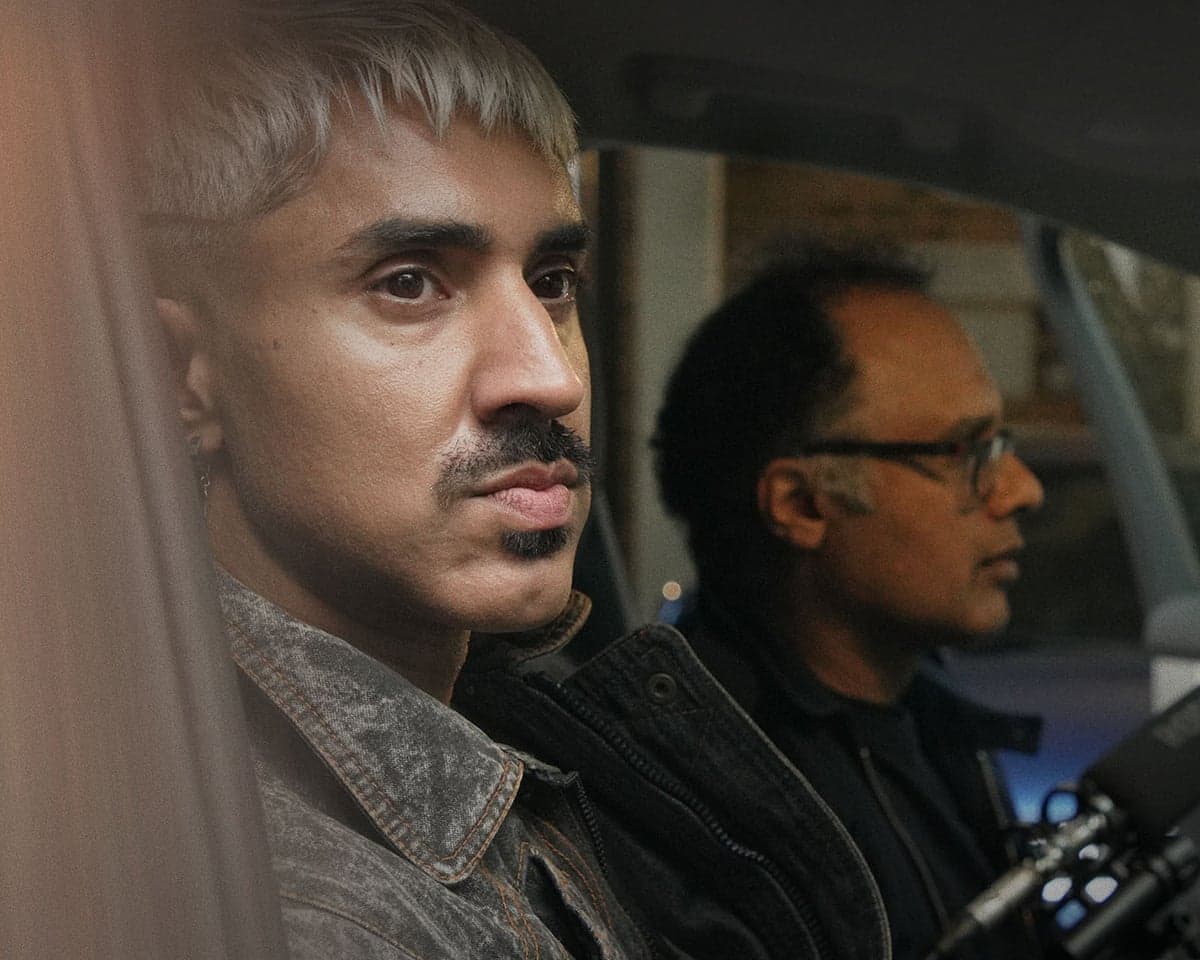 Mobeen Azhar and Masood Khan are shown sitting in a car in Being Muslim After 9/11.