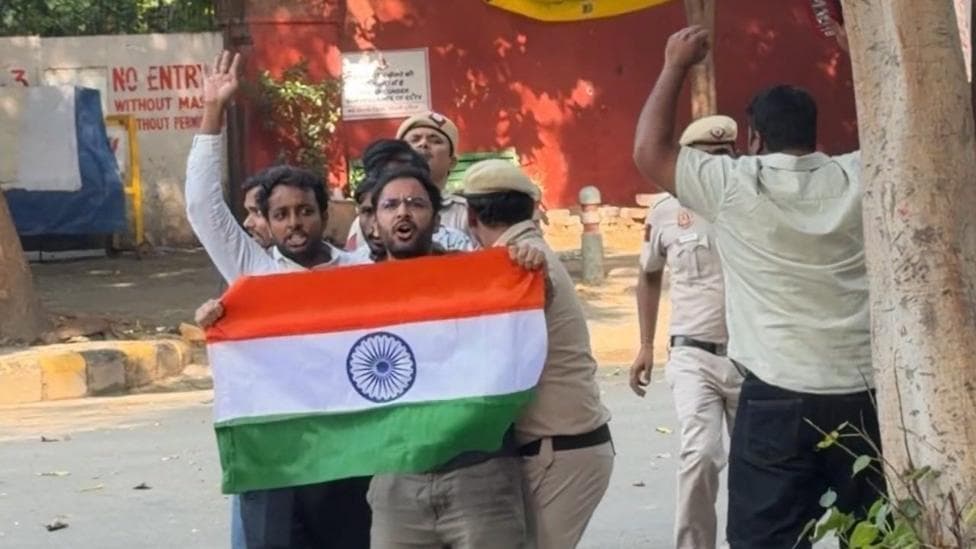 Ashutosh Ranka seen holding the Indian flag with police dragging him