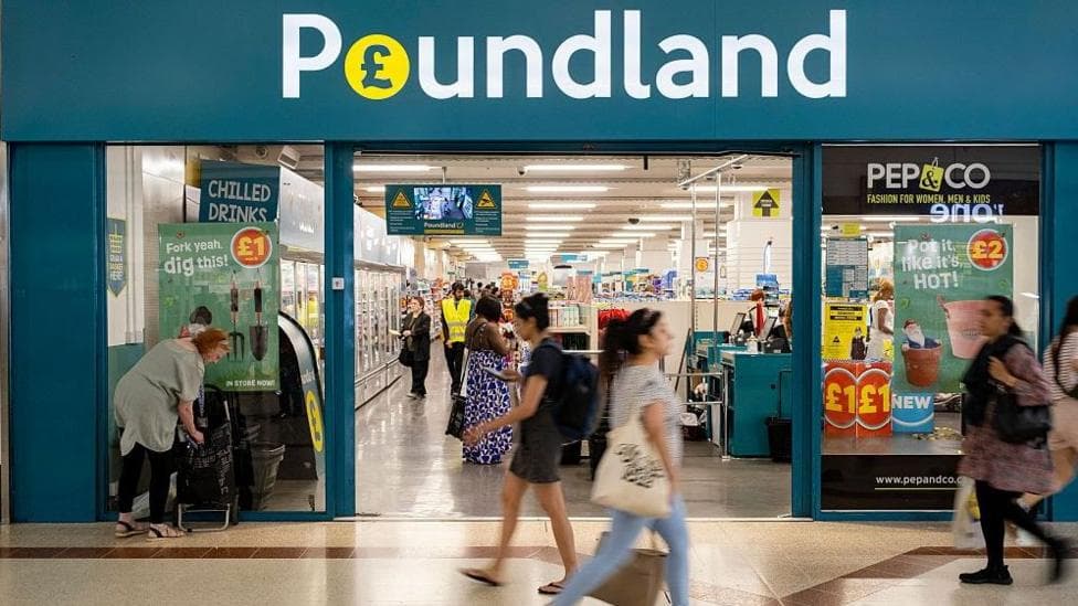 Exterior shot of a Poundland store with people walking past it