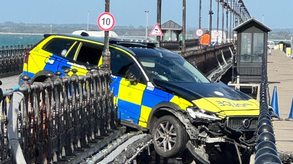 Police car through railings on Ryde Pier.