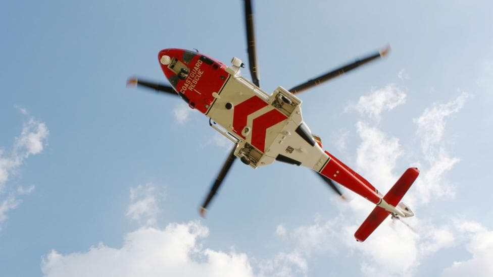 A view up towards a helicopter.