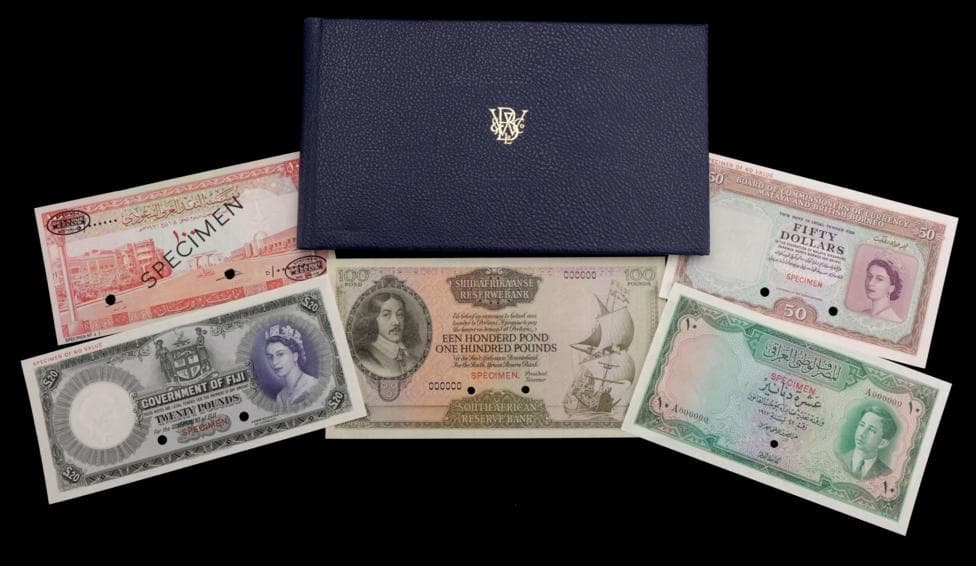 Five banknotes laid out on a black background