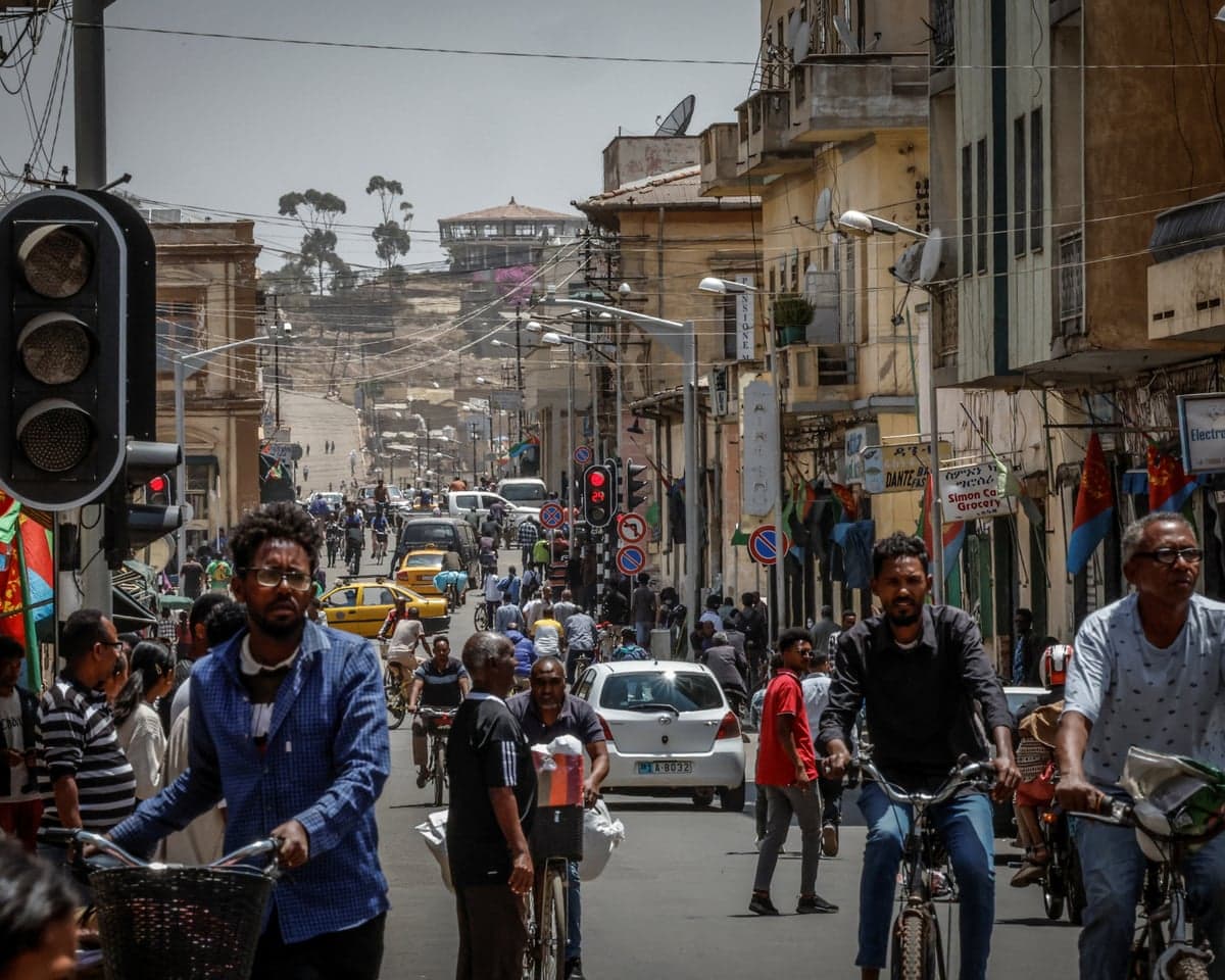 People and vehicles on a busy street in Asmara