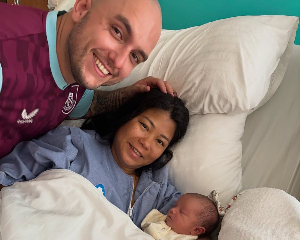 Closeup of Matthew Cross and Khin Thant Zin with their new baby, William