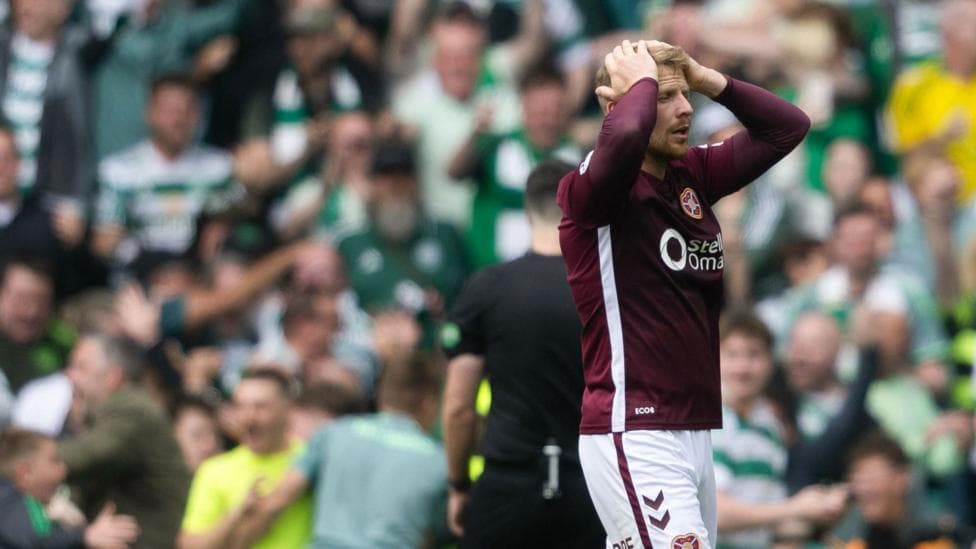 Hearts defender Stephen Kingsley pictured dejected at Celtic Park