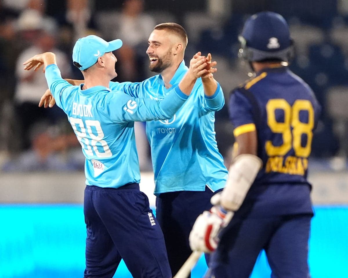 Harry Brook and Will Jacks celebrate a wicket as Sri Lanka's batsman looks on