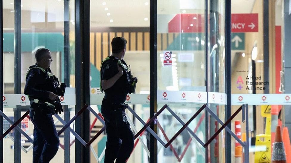 Police are seen outside Alfred Hospital in Melbourne, where Australian independent lawmaker Helen Haines was airlifted to for treatment with critical injuries after being struck by a car outside her office in Wangaratta