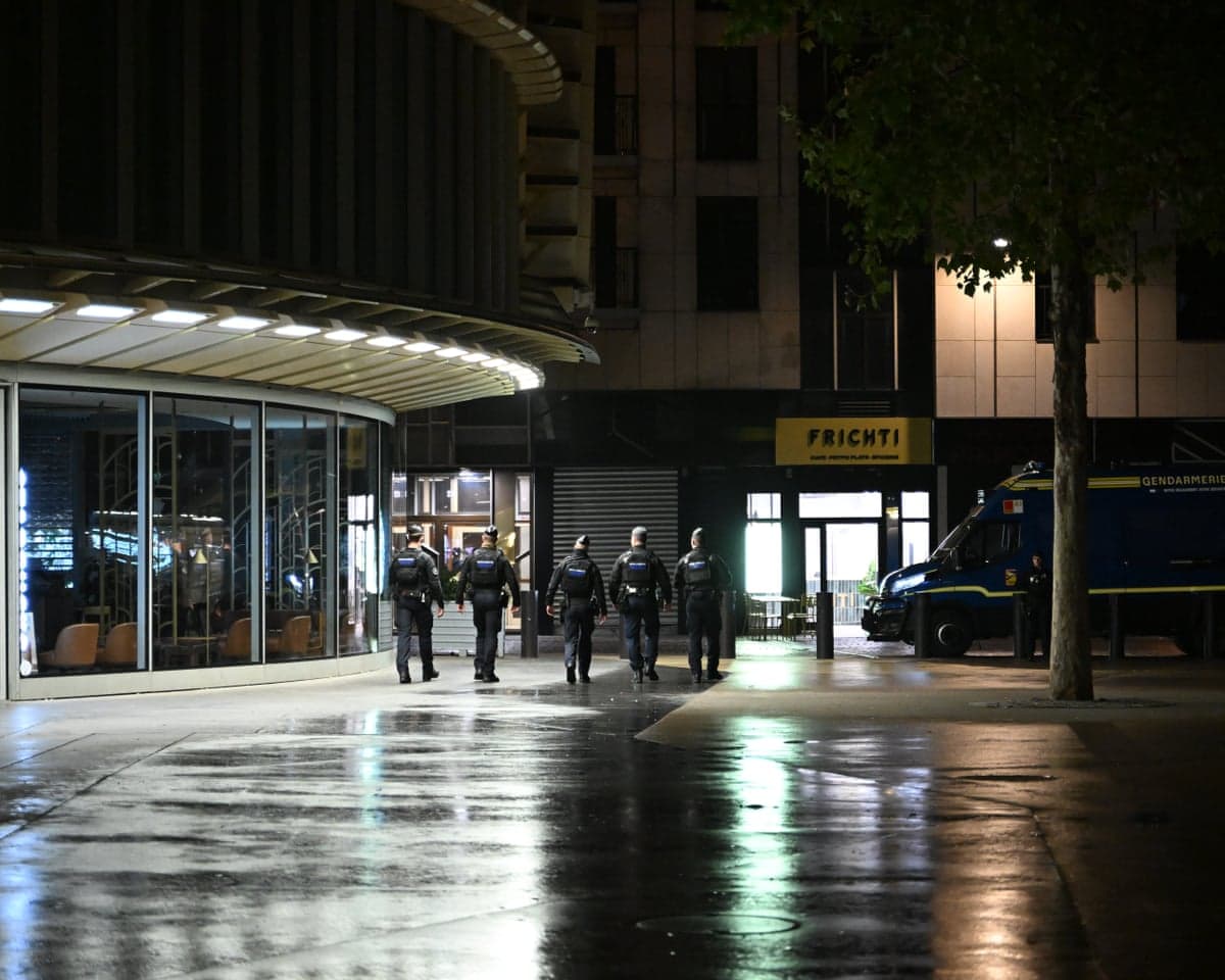 deserted street with a line of police officers walking