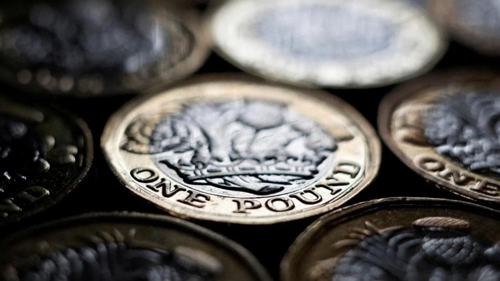 Several £1 coins laid on a flat surface