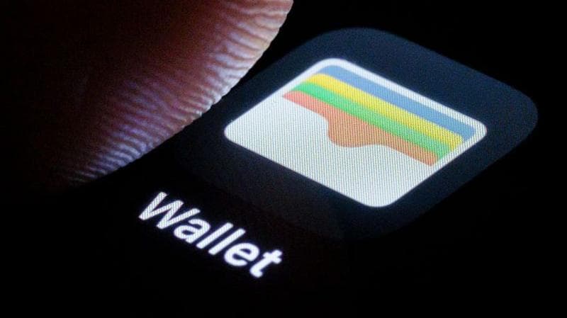 A finger pressing the wallet app logo on an iPhone