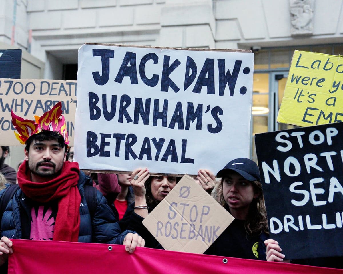 Protesters hold signs reading 'Jackdaw: Burnham's Betrayal at a climate demonstration in London