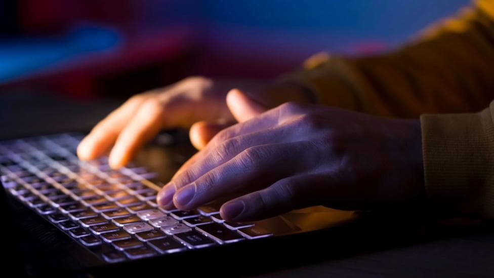 Hands on a computer keyboard