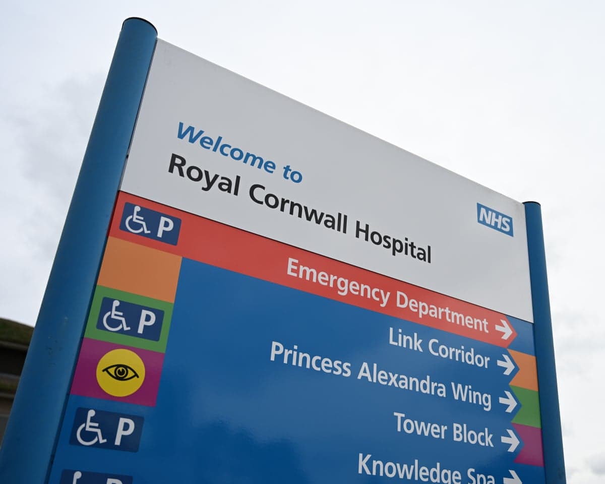 A hospital sign reads Welcome to Royal Cornwall Hospital with directions pointing to various departments