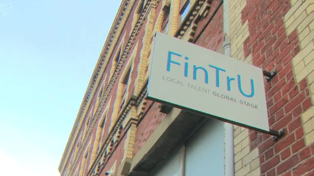 A white sign with 'FinTru' in blue writing.