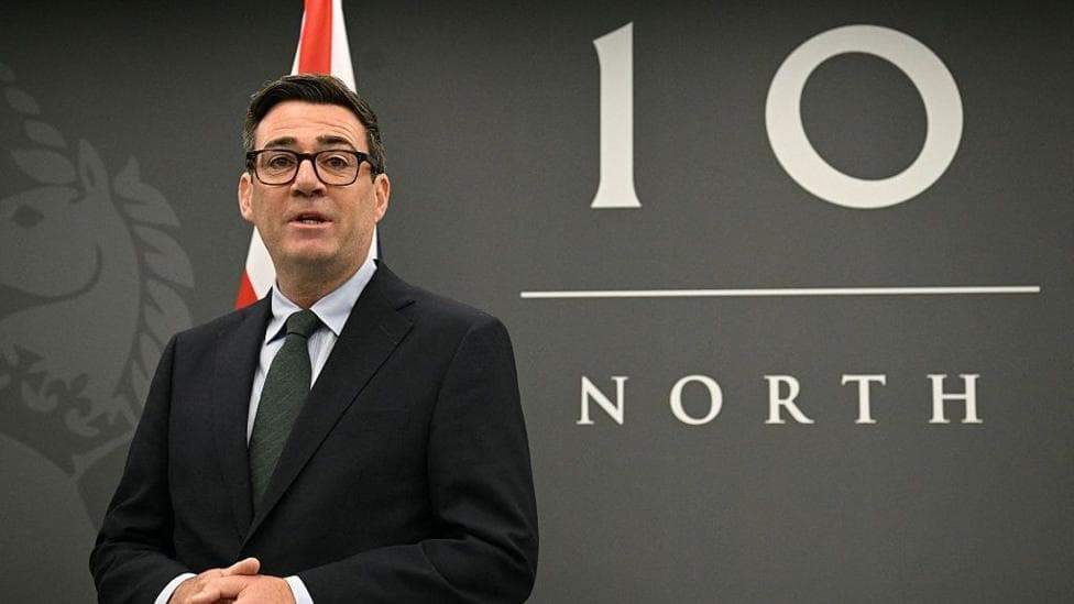 Andy Burnham stands in front of a Number 10 North sign and a Union flag.