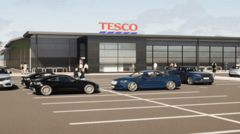 A concept image of the Tesco proposed for Portree on Skye. It is a rectangle-shaped building with a glass frontage. In front of the building is a car park with cars parked in spaces.