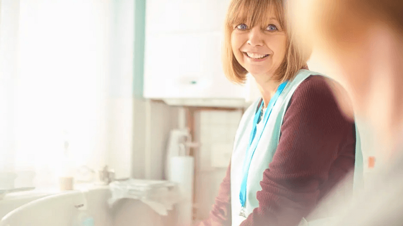 Care home staff member smiling at a colleague