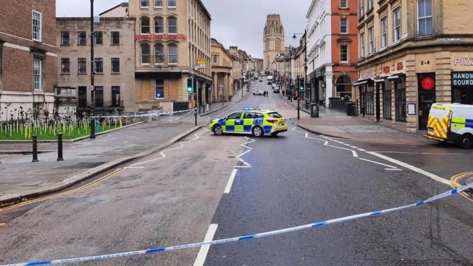 Park Street is closed with a police car in the middle of the road, with police tape in the foreground