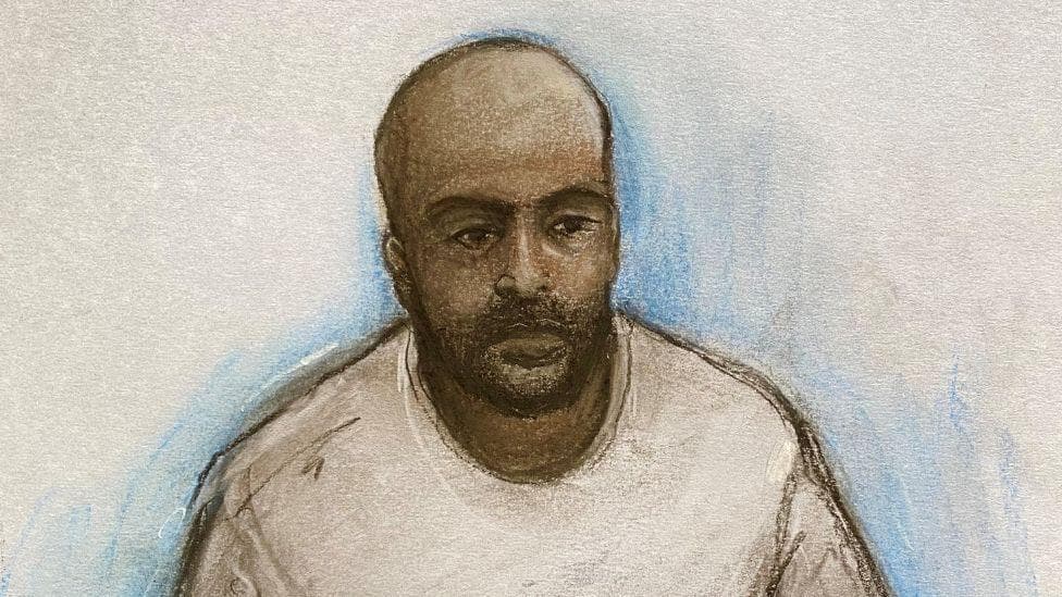 An artist's impression of Hadi Alodid, he has a bald head, black beard and wearing a grey sweatshirt