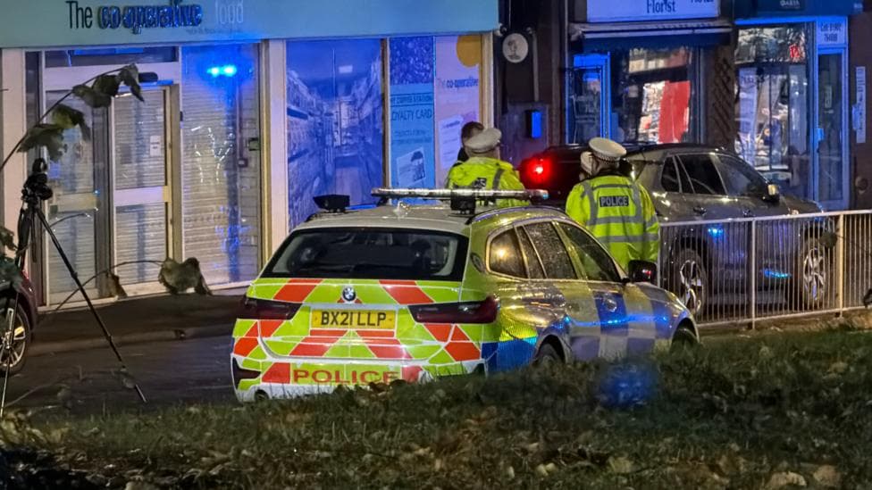 A police car on a street at night.