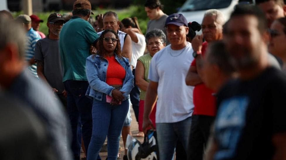 People queue outside a polling station before voting on the day of Brazil's presidential runoff election, in Brasilia, Brazil.