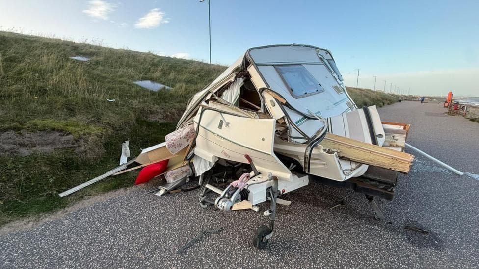 Smashed up caravan on a road