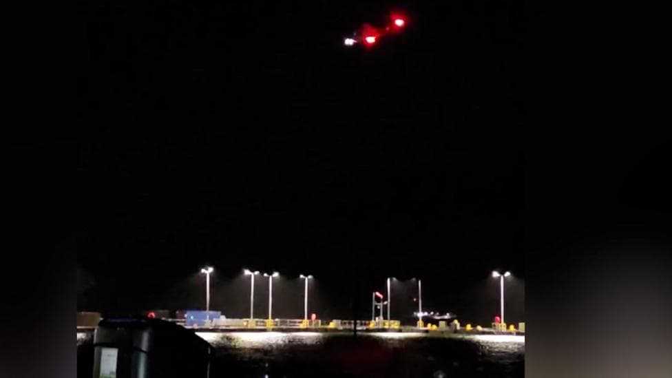 A coastguard helicopter hovering over the coast of Largs