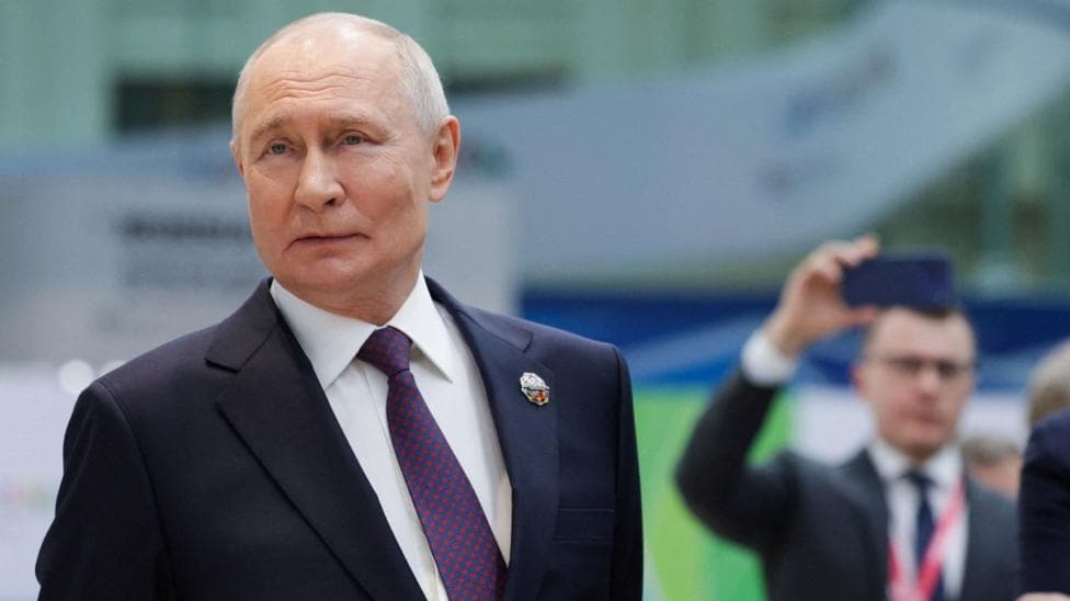Russian President Vladimir Putin looking to the side as he stands during a presentation of Russian technology at the Russia-Africa Summit.
