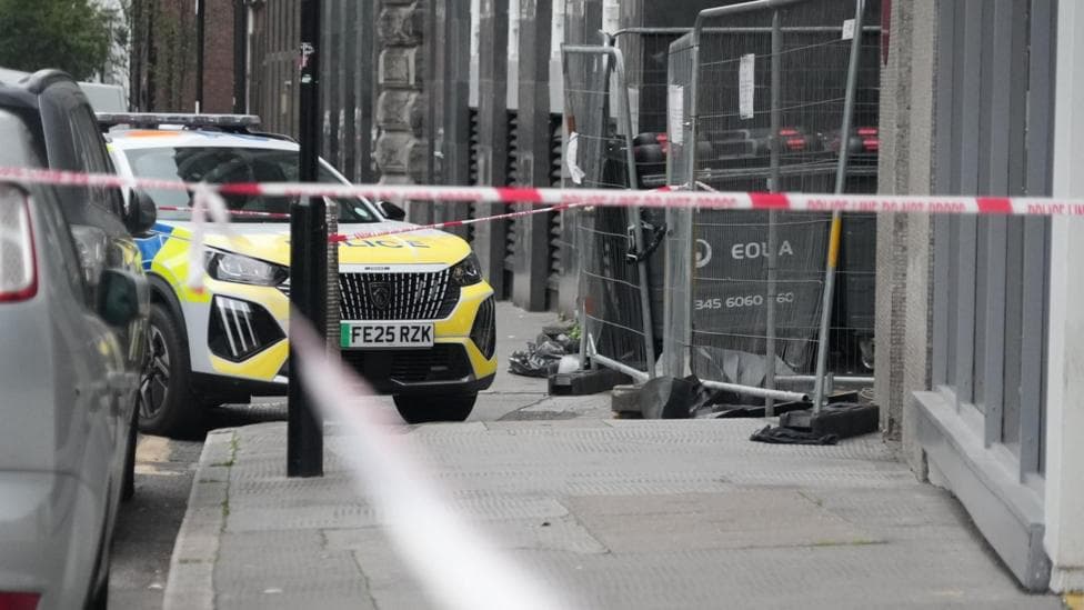 A police car outside at the Thistle City Barbican Hotel. The area is surrounded by police tape