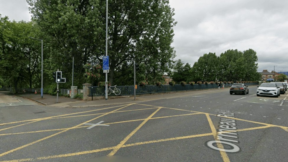 Google maps of Ormeau Bridge at its junction with the Annadale Embankment.
There are cars on the road and a yellow box on the ground. The traffic light is green