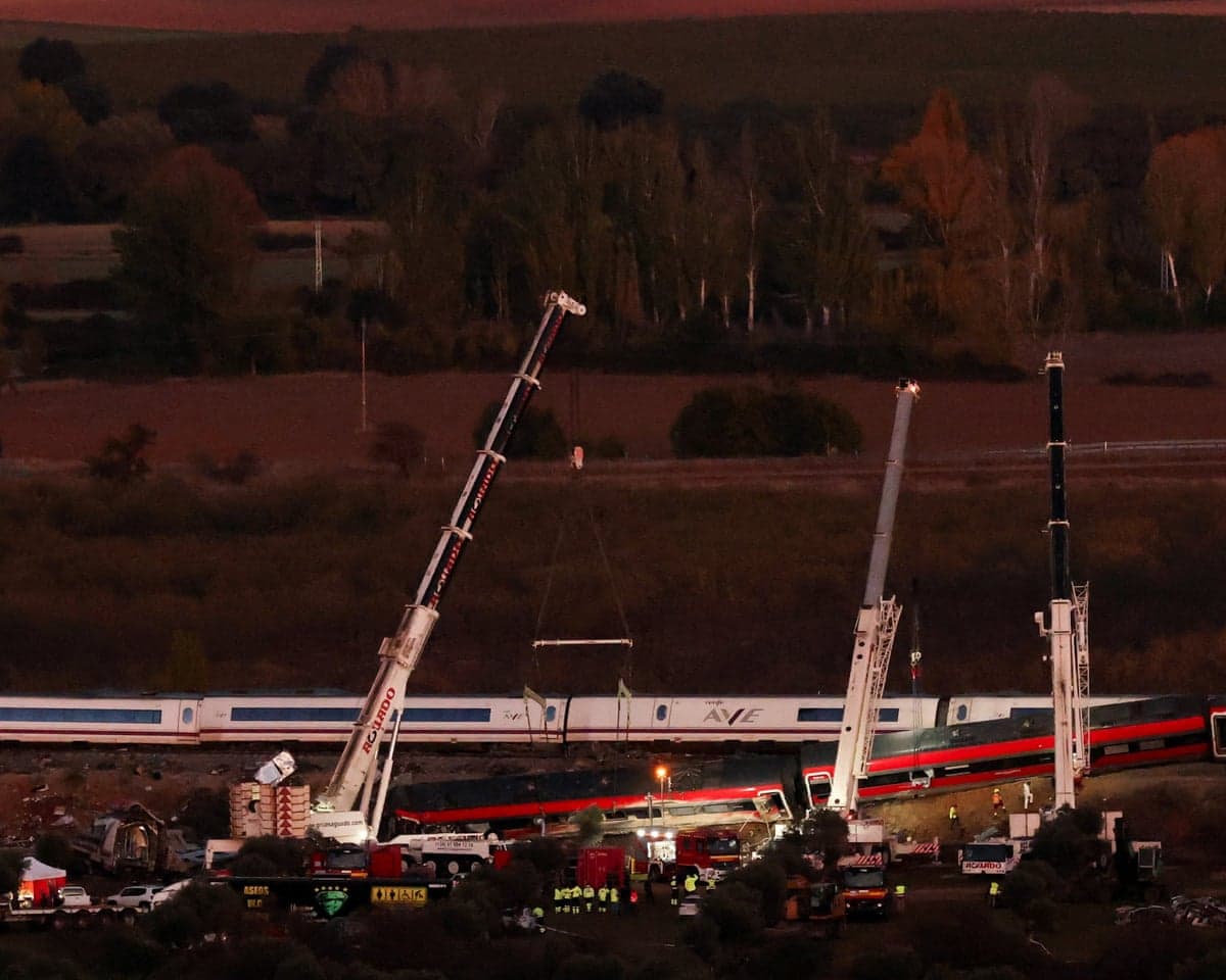 Cranes are used at the site of the collision after two high-speed trains crashed in Spain